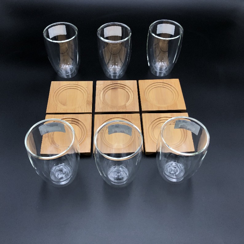 A Set of 6 Bamboo coaters/  trays with 6 doublewalled thermo glasses to match