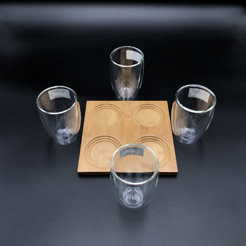 A Set of a 4 section Bamboo tray with 4 doublewalled thermo glasses to match